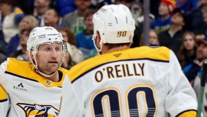 Nashville Predators' Jonathan Marchessault, left, is congratulated by teammates Steven Stamkos, centre, and Ryan O'Reilly (90) after scoring during the third period of an NHL hockey game against the St. Louis Blues, Friday, Dec. 27, 2024, in St. Louis. (Scott Kane/AP)