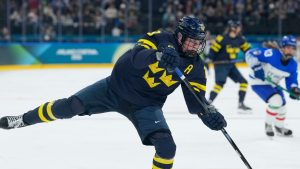 Sweden's Sara Hjalmarsson scores her side's third goal during a preliminary round match of women's ice hockey between Sweden and Italy at the 2026 Winter Olympics, in Milan, Italy, Saturday, Feb. 7, 2026. (Hassan Ammar/AP Photo)