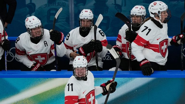 Switzerland's Laura Zimmermann, centre, celebrates after scoring her side's opening goal during a preliminary round match of women's ice hockey between Switzerland and Czechia at the 2026 Winter Olympics, in Milan, Italy, Friday, Feb. 6, 2026. (Hassan Ammar/AP)