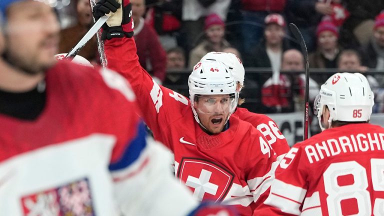 Switzerland's Pius Suter (44) celebrates after scoring his side's third goal during a preliminary round match of men's ice hockey between Switzerland and Czechia at the 2026 Winter Olympics, in Milan, Italy, Sunday, Feb. 15, 2026. (Petr David Josek/AP Photo)