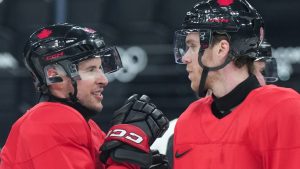 Team Canada captain Sidney Crosby, left, talks with forward Connor McDavid as they take part in practice during the 2026 Milan Cortina Winter Olympics in Milan, Italy on Sunday, February 8, 2026. (Nathan Denette/CP)