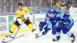 Boston Bruins defenceman Charlie McAvoy (73) moves the puck away from Tampa Bay Lightning left wing Brandon Hagel (38) during the first period of a Stadium Series NHL hockey game Sunday, Feb. 1, 2026, in Tampa, Fla. (Chris O'Meara/AP)