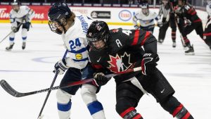 Canada's Blayre Turnbull (40) and Finland's Viivi Vainikka (24) battle for the puck during second period hockey action at the IIHF Women's World Hockey Championship in Utica, N.Y., Thursday, April 4, 2024. (Christinne Muschi/THE CANADIAN PRESS)