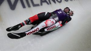 Canada's Devin Wardrope and Cole Zajanski, right, slide down the track during a men's doubles luge training session at the 2026 Winter Olympics, in Cortina d'Ampezzo, Italy, Monday, Feb. 9, 2026. (Aijaz Rahi/AP Photo)