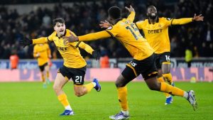 Wolverhampton Wanderers' Rodrigo Gomes, left, celebrates scoring their second goal during their English Premier League match against Aston Villa in Wolverhampton, England, Friday, Feb. 27, 2026. (Nick Potts/PA via AP)
