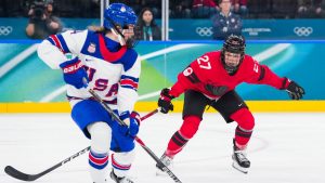 Team Canada's Emma Maltais (27) defends against United States' Caroline Harvey (4) during the first period in Women's Preliminary Round hockey at the Milano Cortina 2026 Olympic Winter Games in Italy on Tuesday, February 10, 2026. (Leah Hennel/COC)
