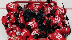 Canada players huddle before a preliminary round match of women's ice hockey between Canada and the United States at the 2026 Winter Olympics, in Milan, Italy, Tuesday, Feb. 10, 2026. (Hassan Ammar/AP Photo)