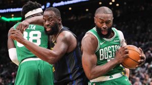 Boston Celtics guard Jaylen Brown, right, grabs a rebound against Golden State Warriors forward Draymond Green (23) during the first half of an NBA basketball game, Wednesday, March 18, 2026, in Boston. (Charles Krupa/AP)