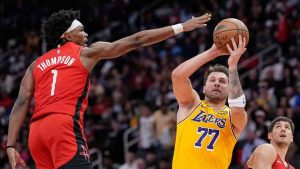 Los Angeles Lakers' Luka Doncic (77) shoots as Houston Rockets' Amen Thompson (1) defends during the first half of an NBA basketball game Monday, March 16, 2026, in Houston. (David J. Phillip/AP)