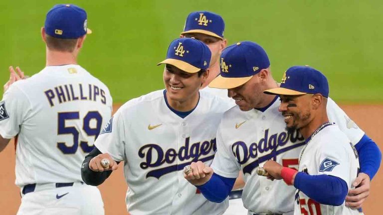 Los Angeles Dodgers Shohei Ohtani, Freddie Freeman and Mookie Betts pose with their rings during a World Series Champion ring ceremony prior to a baseball game against the Arizona Diamondbacks in Los Angeles, Friday, March 27, 2026. (Caroline Brehman/AP)