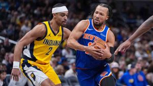New York Knicks guard Jalen Brunson (11) drives on Indiana Pacers guard Andrew Nembhard (2) during the first half of an NBA basketball game in Indianapolis, Friday, March 13, 2026. (Michael Conroy/AP)