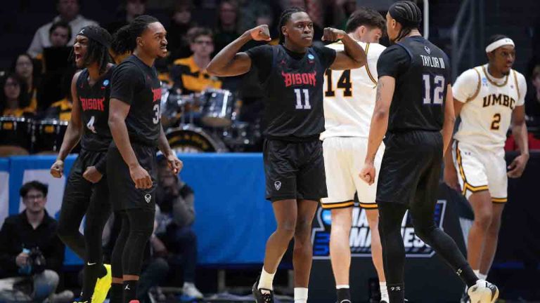 Howard guard Ose Okojie (11), center, reacts after scoring and drawing a foul during the first half in a First Four college basketball game in the NCAA Tournament against UMBC, Tuesday, March 17, 2026, in Dayton, Ohio. (Kareem Elgazzar/AP)
