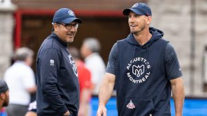 Montreal Alouettes head coach Jason Maas, right, and offensive coordinator and quarterback coach Anthony Calvillo smile during warm up prior to their pre-season CFL football game against the Toronto Argonauts in Montreal, Saturday, May 25, 2024. (Christinne Muschi/CP)