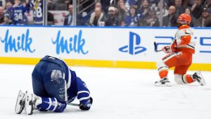 Toronto Maple Leafs Auston Matthews (34) is injured by Anaheim Ducks Radko Gudas (7) during second period NHL hockey action in Toronto on Thursday, March 12, 2026. (Nathan Denette/CP)