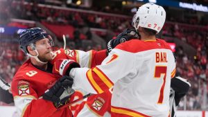 Florida Panthers center Sam Bennett (9) brawls with Calgary Flames defenseman Kevin Bahl (7) during the second period of an NHL hockey game, Friday, Nov. 28, 2025, in Sunrise, Fla. (AP Photo/Rebecca Blackwell)