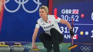 Canada's Emma Miskew competes during the women's curling round robin session against Britain at the 2026 Winter Olympics, in Cortina d'Ampezzo, Italy, Saturday, Feb. 14, 2026. (AP Photo/Fatima Shbair)