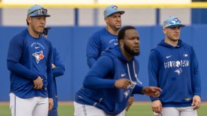 Toronto Blue Jays' Kazuma Okamoto, left, George Springer and Daulton Varsho, right, watch as Vladimir Guerrero Jr. does a base running drill at Spring Training in Dunedin, Fla., on Thursday, Feb. 19, 2026. THE CANADIAN PRESS/Frank Gunn