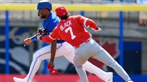 Canada second baseman Tyler Black (7) tags out Toronto Blue Jays' Jesús Sánchez after he was caught in a rundown during the first inning of an exhibition baseball game Tuesday, March 3, 2026, in Dunedin, Fla. (AP Photo/Chris O'Meara)