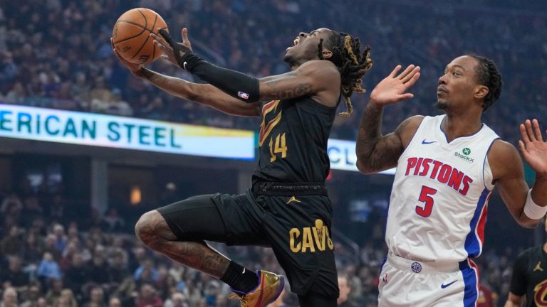Cleveland Cavaliers guard Keon Ellis (14) goes to the basket past Detroit Pistons forward Ronald Holland II (5) in the first half of an NBA basketball game in Cleveland, Tuesday, March 3, 2026. (Sue Ogrocki/AP)