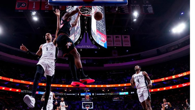 Philadelphia 76ers' VJ Edgecombe, centre, dunks the ball as San Antonio Spurs' Victor Wembanyama, left, comes over to defend during the first half of an NBA game, Tuesday, March 3, 2026, in Philadelphia. (Chris Szagola/AP)