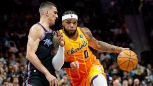 Charlotte Hornets forward Miles Bridges (0) drives into Miami Heat guard Tyler Herro, left, during the second half of an NBA basketball game in Charlotte, N.C., Friday, March 6, 2026. (Nell Redmond/AP)