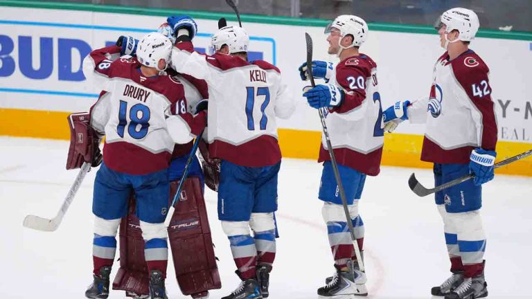 Colorado Avalanche players, from left, centre Jack Drury (18), centre Parker Kelly (17), centre Ross Colton (20) and defenceman Josh Manson (42) surround goaltender Scott Wedgewood, second from left, after they beat the Dallas Stars in an overtime shootout of an NHL hockey game Friday, March 6, 2026, in Dallas. (Julio Cortez/AP)