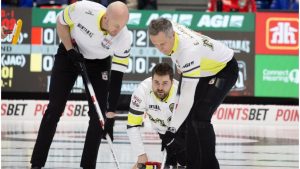Ryan, left, and EJ Harnden sweep the rock just released by Team Manitoba-Dunstone skip Matt Dunstone during the semifinal against Team Canada at the Montana's Brier Canadian men's curling championship, in St. John's, N.L., on Sunday, March 8, 2026. THE CANADIAN PRESS/Paul Daly