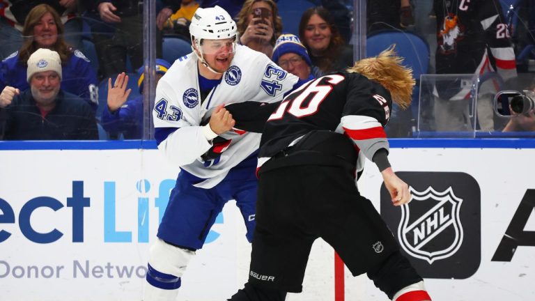Tampa Bay Lightning defenseman Darren Raddysh (43) and Buffalo Sabres defenseman Rasmus Dahlin fight during the first period of an NHL hockey game, Sunday, March 8, 2026, in Buffalo, N.Y. (Jeffrey T. Barnes/AP)