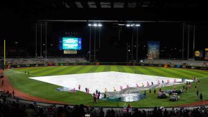 The grounds crew remove a tarp after a rain delay before a World Baseball Classic game between Panama and Canada in San Juan, Puerto Rico, Sunday, March 8, 2026. (Fernando Llano/AP)