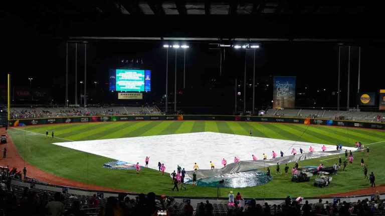 The grounds crew remove a tarp after a rain delay before a World Baseball Classic game between Panama and Canada in San Juan, Puerto Rico, Sunday, March 8, 2026. (Fernando Llano/AP)
