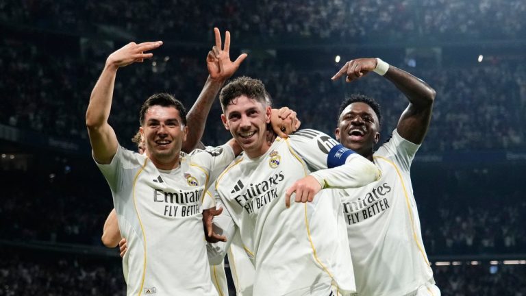 Real Madrid's Federico Valverde, center, celebrates after scoring his third goal during a first leg round of 16 Champions League soccer match between Real Madrid and Manchester City in Madrid, Spain, Wednesday, March 11, 2026. (AP Photo/Jose Breton)