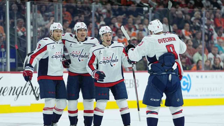 Washington Capitals' Ryan Leonard (9) and teammates Jakob Chychrun, left, Dylan Strome, and Alex Ovechkin celebrate Leonard's goal during the first period of an NHL hockey game against the Philadelphia Flyers, Wednesday, March 11, 2026, in Philadelphia. (Matt Rourke/AP)
