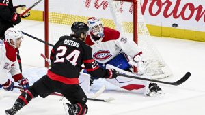 Montreal Canadiens goaltender Jacob Fowler (32) tracks the puck as Ottawa Senators' Dylan Cozens (24) falls to the ice during third period NHL hockey action in Ottawa, on Wednesday, March 11, 2026. THE CANADIAN PRESS/Spencer Colby