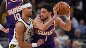 Indiana Pacers guard Andrew Nembhard (2) defends Phoenix Suns guard Devin Booker (1) during the first half of an NBA basketball game in Indianapolis, Thursday, March 12, 2026. (Michael Conroy/AP)