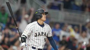 Japan's Shohei Ohtani hits a single home run during the first inning against Venezuela of a World Baseball Classic quarterfinal game, Saturday, March 14, 2026, in Miami. (Lynne Sladky/AP)