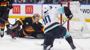 Vancouver Canucks goalie Nikita Tolopilo (60) stops Seattle Kraken's Matty Beniers (10) during the first period of an NHL hockey game, in Vancouver, on Saturday, March 14, 2026. (Darryl Dyck/CP)