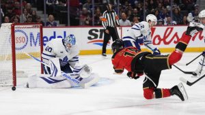 Ottawa Senators' Tim Stutzle (18) falls as he takes a shot on Toronto Maple Leafs goaltender Joseph Woll (60) during second
period NHL hockey action in Ottawa, on Saturday, Mar. 21, 2026. THE CANADIAN PRESS/Justin Tang