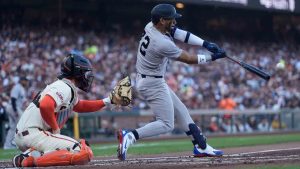 New York Yankees' José Caballero, right, hits an RBI double in front of San Francisco Giants catcher Patrick Bailey, left, during the second inning of a baseball game in San Francisco, Wednesday, March 25, 2026. (Jeff Chiu/AP)