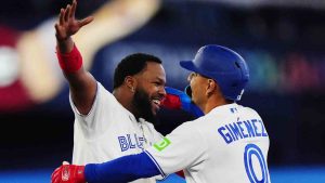 Toronto Blue Jays' Andres Gimenez (0) celebrates his walk-off single against the Athletics with Vladimir Guerrero Jr. (27) during ninth inning MLB baseball action in Toronto on Friday, March 27, 2026. (Frank Gunn/CP)