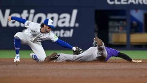 Toronto Blue Jays infielder Ernie Clement (22) tags out Colorado Rockies outfielder Hunter Goodman (15) on an attempted stolen base to end the fifth inning of interleague baseball action in Toronto on Monday, March 30, 2026. (Jon Blacker/CP)