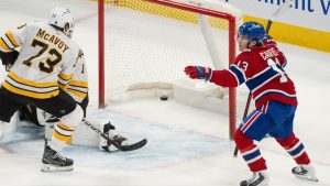 Montreal Canadiens' Cole Caufield (13) celebrates his goal on Boston Bruins goaltender Jeremy Swayman (1) as Bruins' Charlie McAvoy (73) skates in during overtime NHL hockey action in Montreal on Tuesday, March 17, 2026. (Christinne Muschi/CP)