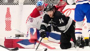 Los Angeles Kings right wing Alex Laferriere, right, passes the puck as Montréal Canadiens goaltender Jakub Dobes sits in goal during the first period of an NHL hockey game Saturday, March 7, 2026, in Los Angeles. (Mark J. Terrill/AP)