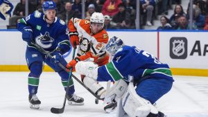 Vancouver Canucks' Marco Rossi (93) watches goalie Kevin Lankinen (32) stop Anaheim Ducks' Ryan Poehling (25) during the first period of an NHL hockey game, in Vancouver, on Tuesday, March 24, 2026. (Darryl Dyck/CP)