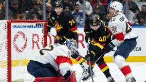 Vancouver Canucks' Elias Pettersson (40) is stopped by Florida Panthers goaltender Sergei Bobrovsky (72) as Gustav Forsling (42) defends during the third period of an NHL hockey game in Vancouver, on Tuesday, March 17, 2026. (Ethan Cairns/CP)