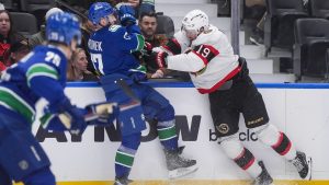 Vancouver Canucks' Filip Hronek (17) and Ottawa Senators' Drake Batherson (19) collide during the second period of an NHL hockey game, in Vancouver, on Monday, March 9, 2026. (Darryl Dyck/CP)