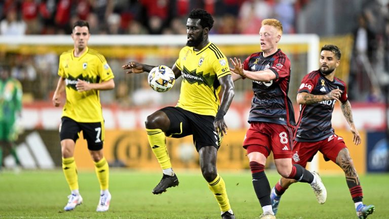 Former Columbus Crew midfielder Derrick Jones, second left, is defended from behind by Toronto FC midfielder Matty Longstaff (8) during first half MLS soccer match, in Toronto, Sept. 18, 2024. (Chris Katsarov/CP)