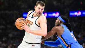Denver Nuggets center Nikola Jokić, left, drives against Oklahoma City Thunder guard Luguentz Dort (5) during the first half of an NBA basketball game, Monday, Mar. 9, 2026, in Oklahoma City. (Gerald Leong/AP)