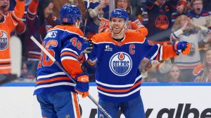 Edmonton Oilers’ Connor McDavid (97) celebrates a goal with Max Jones (46) during second period NHL action, in Edmonton on Saturday March 28, 2026. (James Maclennan/CP)