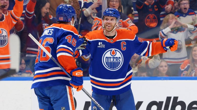 Edmonton Oilers’ Connor McDavid (97) celebrates a goal with Max Jones (46) during second period NHL action, in Edmonton on Saturday March 28, 2026. (James Maclennan/CP)