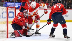 Calgary Flames centre Ryan Strome (22) battles for the puck against Washington Capitals goaltender Logan Thompson (48) and defenseman Martin Fehérváry, right, during the second period of an NHL hockey game, Monday, March 9, 2026, in Washington. (Nick Wass/AP)